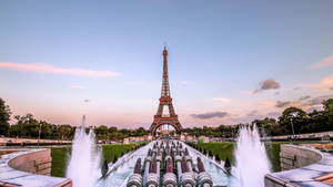 A Romantic View Of The Iconic Eiffel Tower, Sparkling In The Lights Of Paris. Wallpaper