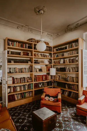 A Room With A Large Number Of Bookshelves Wallpaper