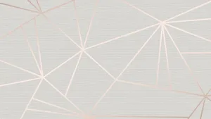 A Rose Gold Computer Sits Atop A Mahogany Desk. Wallpaper