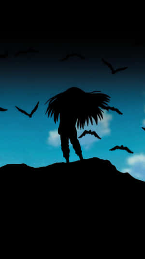 A Silhouette Of A Man With Long Hair Standing On A Hill Wallpaper