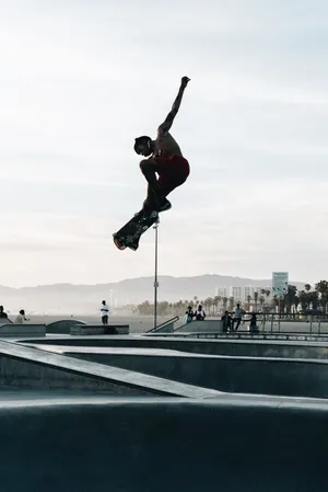A Skateboarder Performing A Grind On A Rail Wallpaper