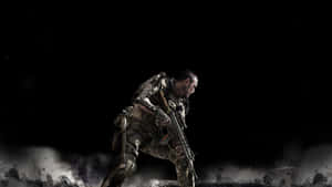 A Soldier Is Standing In The Dark With A Gun Wallpaper