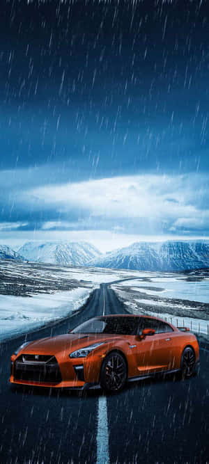 A Sports Car Driving Down A Road In The Rain Wallpaper