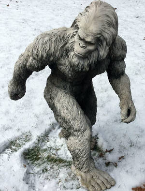 A Statue Of A Bigfoot In The Snow Wallpaper