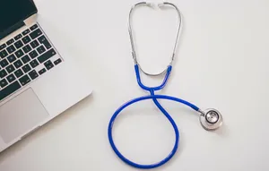 A Stethoscope Next To A Laptop And A Laptop Wallpaper