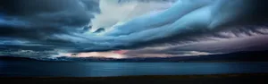 A Stormy Sky Over A Lake And Mountains Wallpaper