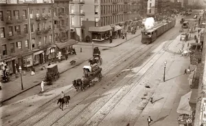 A Street With A Train And Horses Wallpaper