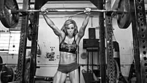 A Strong Athlete Making His Way Up The Ladder Wallpaper