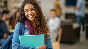 A Student Holding Up A 