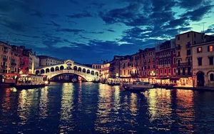 A Stunning Aerial View Of The Italian Countryside, With Lush Green Hills And Winding Valleys. Wallpaper