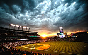 A Stunning View Of A Baseball Stadium At Sunset Wallpaper