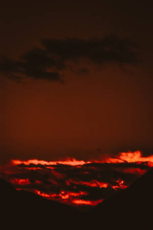 A Stunning View Of Fiery Red Clouds During A Red-orange Sunset. Wallpaper
