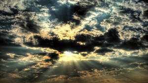 A Sunbeam Shining Through The Clouds Wallpaper