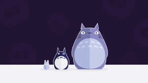 A Totoro And A Rabbit Standing Next To Each Other Wallpaper