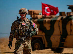 A Turkey Soldier Standing Tall With The American Flag. Wallpaper