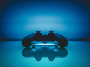 A Video Game Controller Is Sitting On A Blue Surface Wallpaper