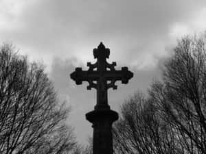 A View Of A Black Cross Against The Night Sky. Wallpaper