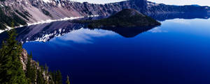 A View Of The Cascading Waterfalls Against A Scenic Mountainous Background. Wallpaper