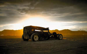 A Vintage Car Sitting In The Desert Wallpaper