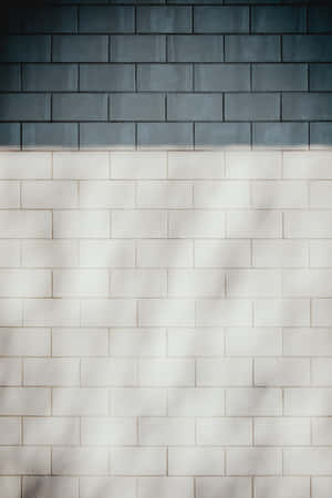A White And Blue Tile Wall With A Shadow Wallpaper