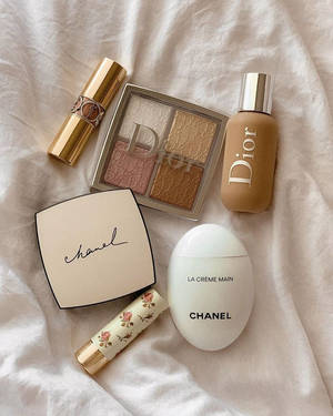 A White Bed With Cosmetics And A Chanel Bag Wallpaper