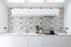 A White Kitchen With A Black And White Polka Dot Wallpaper Wallpaper