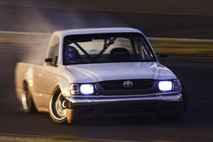 A White Truck Driving On A Track Wallpaper