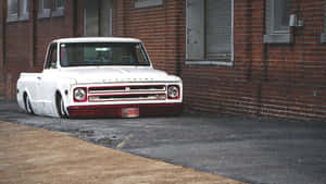 A White Truck Parked On The Side Of The Road Wallpaper