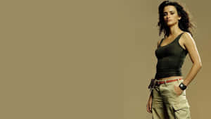 A Woman In A Tank Top And Khaki Pants Wallpaper