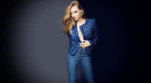 A Woman In Blue Jeans And A Jacket Posing Wallpaper