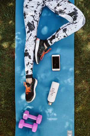 A Woman Is Laying On A Blue Mat Wallpaper