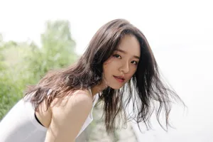 A Woman With Long Hair Posing By The Water Wallpaper