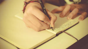 A Woman’s Inspiration - Delightful Process Of Journaling With Her Adorable Fluffy Creature. Wallpaper