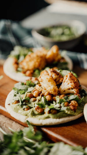 A Wooden Cutting Board With A Few Chicken Tacos On It Wallpaper