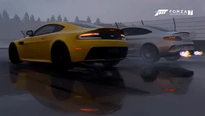 A Yellow Aston Db9 And A Yellow Aston Db9 Wallpaper