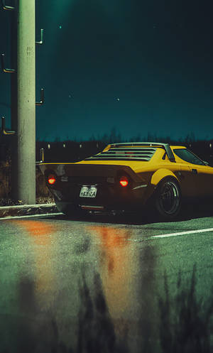 A Yellow Sports Car Parked On A Street Wallpaper