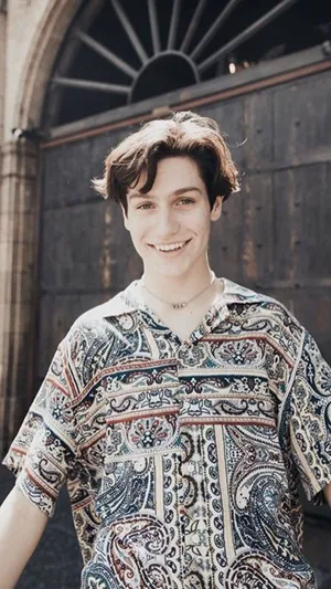 A Young Man Wearing A Paisley Shirt Wallpaper