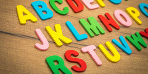 Abc Letters On Wooden Table Wallpaper