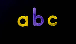 Abc Letters Purple And Yellow Colour Wallpaper