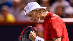 Acclaimed Tennis Athlete Denis Shapovalov In Mid-match Action Wallpaper