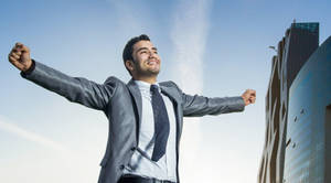 Accomplished Entrepreneur Reveling In Success Wallpaper