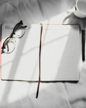 Accounting Notebook With Eyeglasses Wallpaper