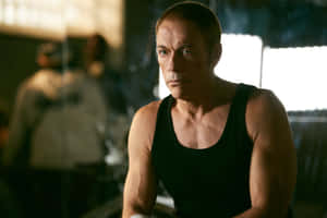 Action Star Jean Claude Van Damme In A Powerful Stance. Wallpaper