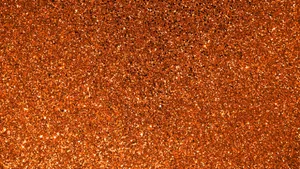 Add A Luxurious Sparkle To Your Space With Orange Glitter Wallpaper