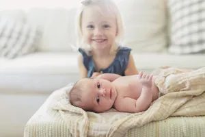 Adorable Brother And Sister Sharing A Sweet Moment Wallpaper