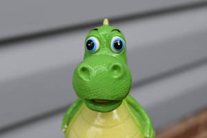 Adorable Toy Dinosaur In Close-up Shot Wallpaper