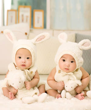 Adorably Cute Babies In Bunny Bonnets Wallpaper