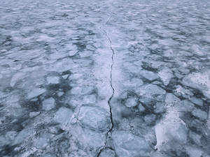 Aerial View Of Cracked Ice Lake Wallpaper