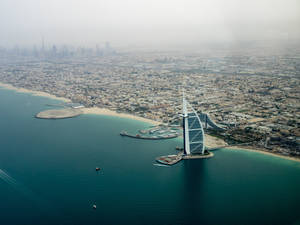 Aerial View Of The Spectacular Burj Al Arab In Dubai Wallpaper