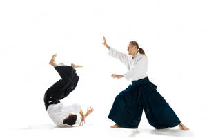 Aikidoka Demonstrating The Aiki-nage Technique In Aikido Wallpaper